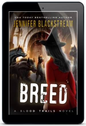 The cover of Breed, Blood Trails #17, by Jennifer Blackstream featured on an ereader. It pictures Shade standing amidst a pack of creepy looking hounds.